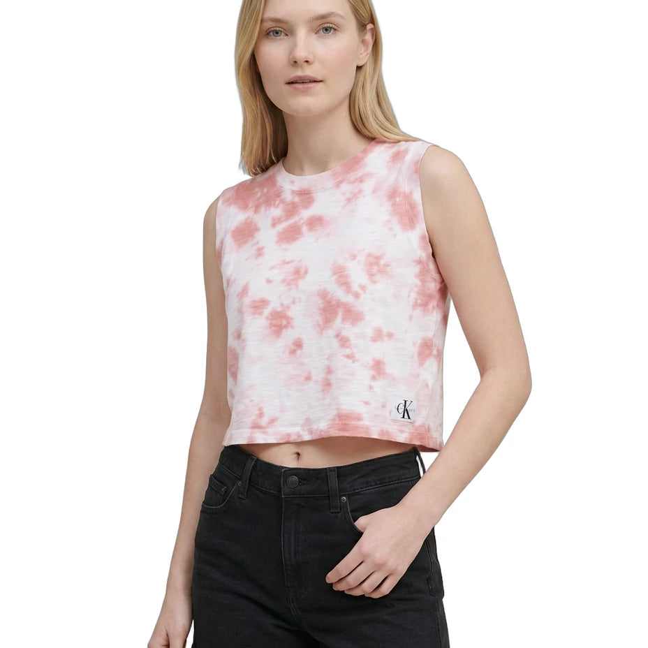 Woman wearing a tie-dye crop top with a brand logo on a white background