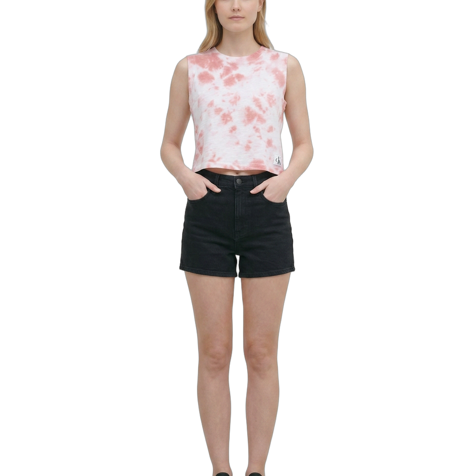 Woman wearing a sleeveless floral top and black shorts on a white background