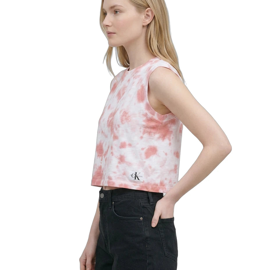 Woman wearing a tie-dye tank top with a brand logo on a white background