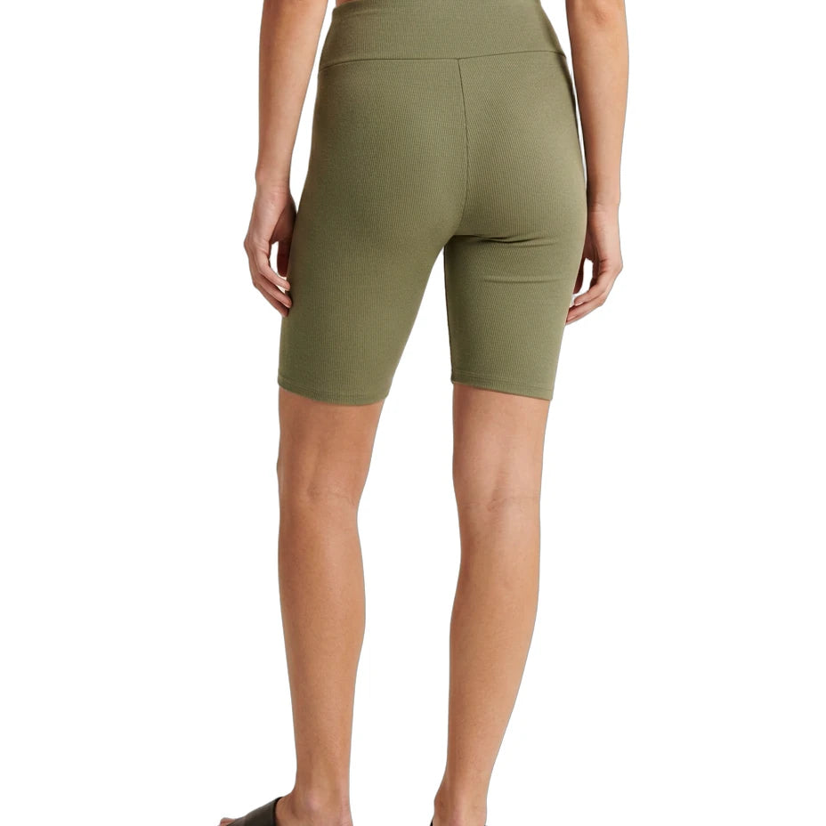 Person wearing olive green shorts on a white background