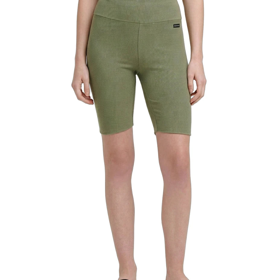 Person wearing green shorts on a white background