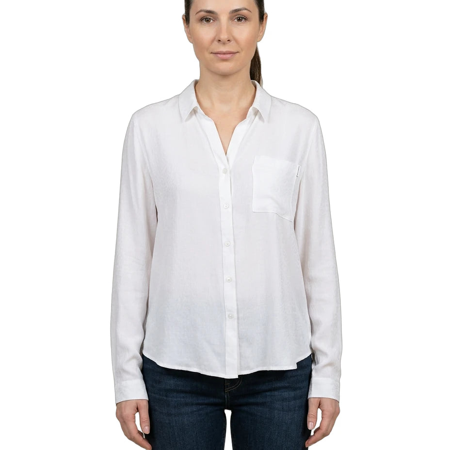 Woman wearing a white shirt and dark jeans on a white background