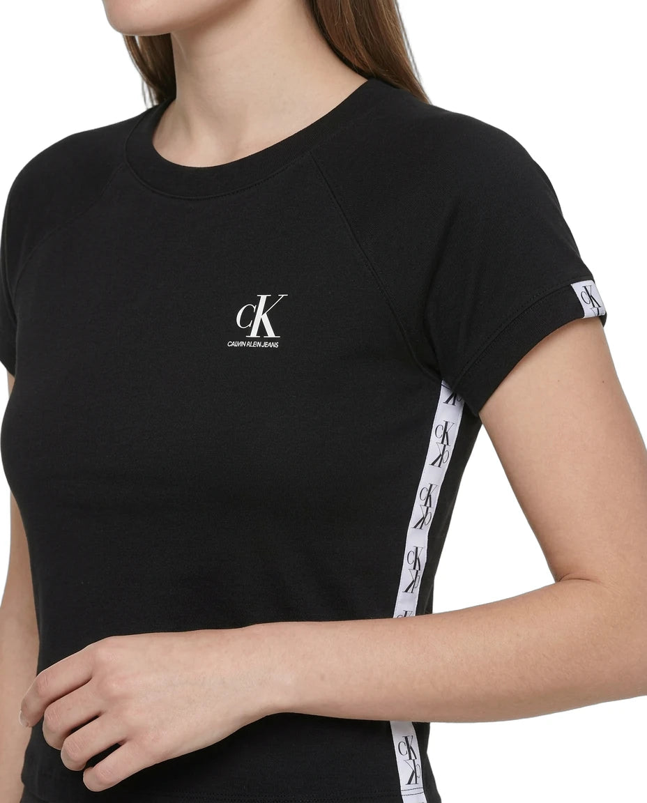 close up of the CK logo on a black Calvin Klein black dress with white tape design on a white background