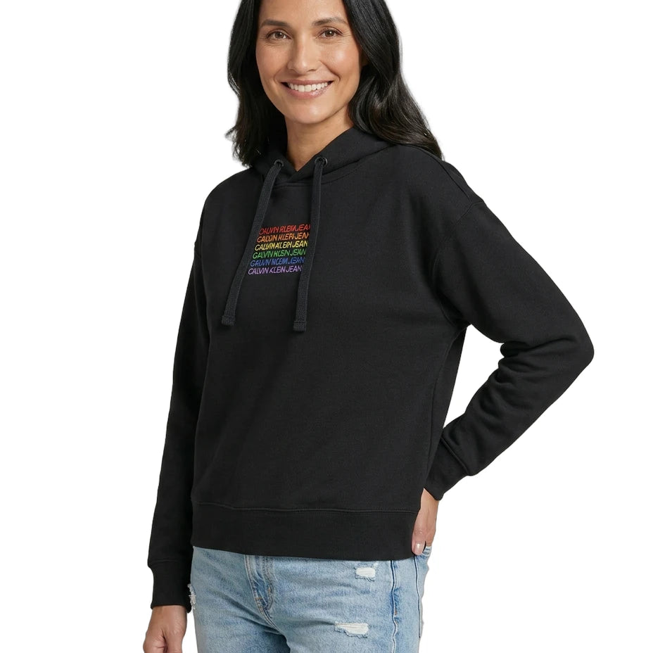Woman wearing a black Calvin Klein hoodie with colorful text design on a white background