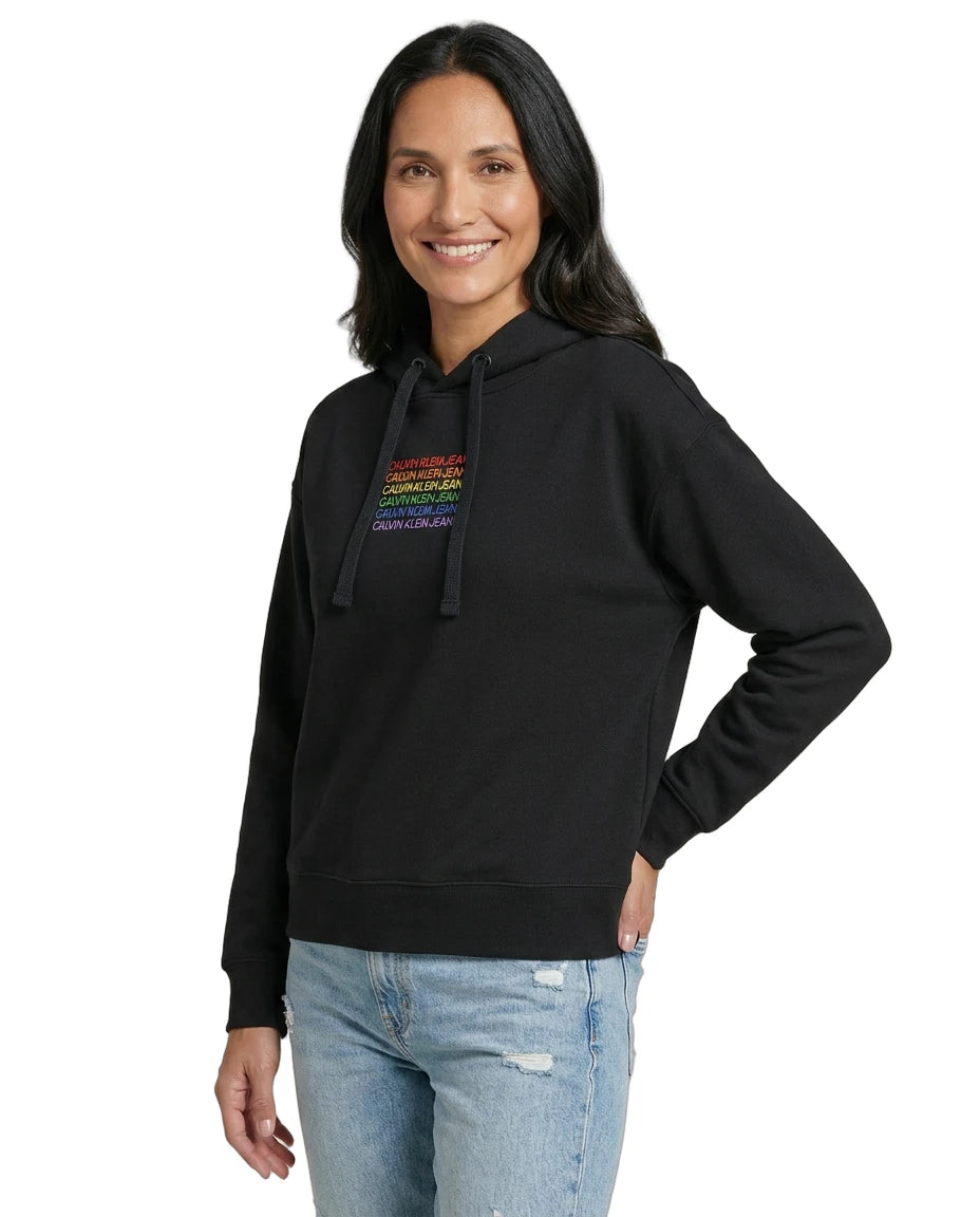 Woman wearing a black Calvin Klein hoodie with colorful text design on a white background