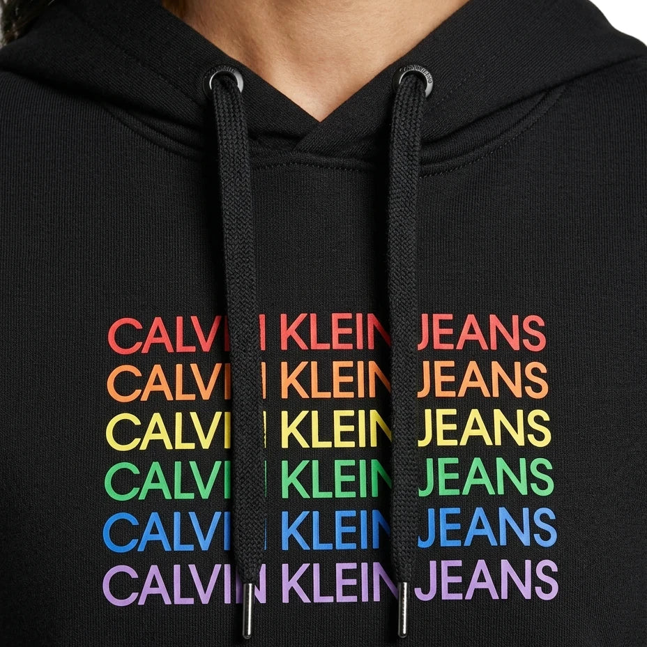 close up of the logo on a black Calvin Klein hoodie with colorful text design on a white background