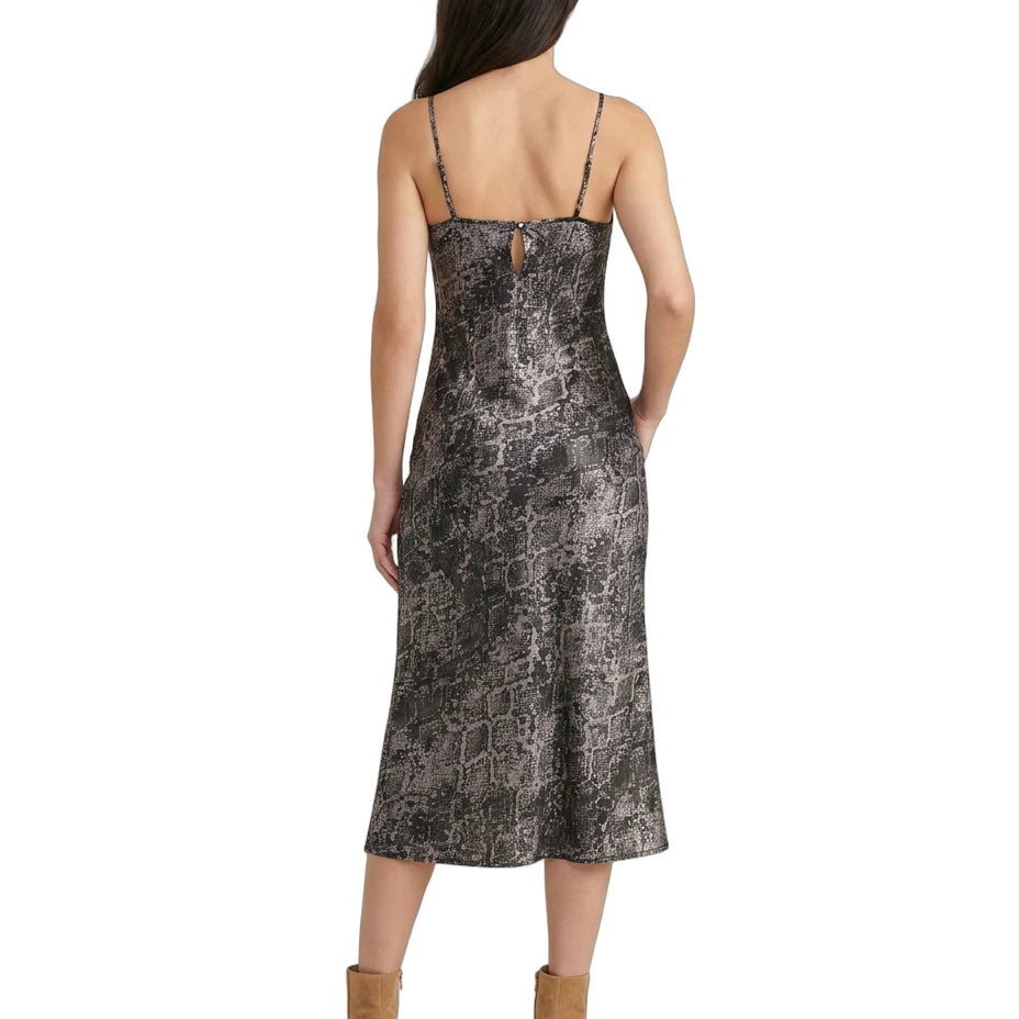 Woman wearing a patterned Calvin Klein dress on a white background