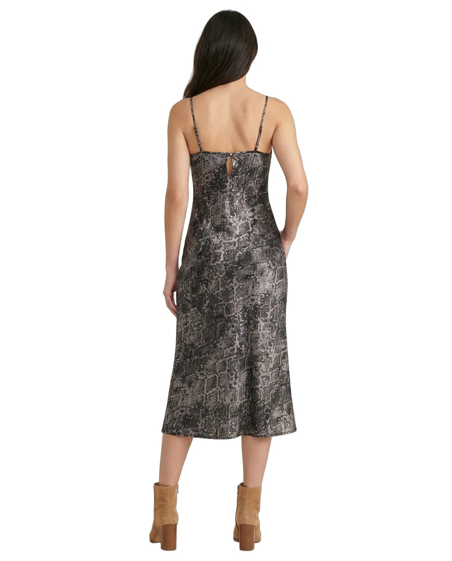 Woman wearing a patterned Calvin Klein dress on a white background