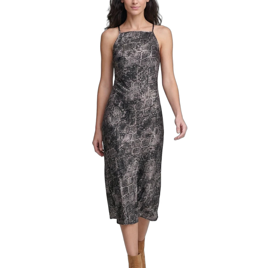 Woman wearing a patterned Calvin Klein dress on a white background
