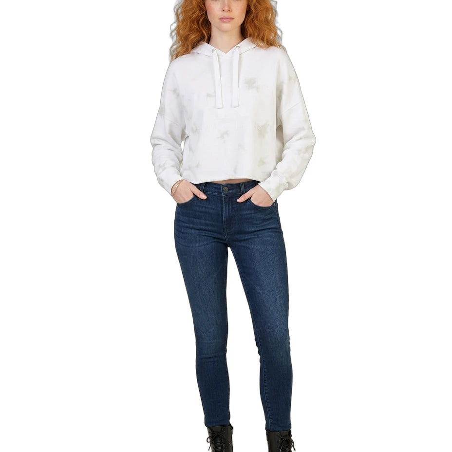 Woman wearing a white Calvin Klein hoodie and blue jeans on a white background