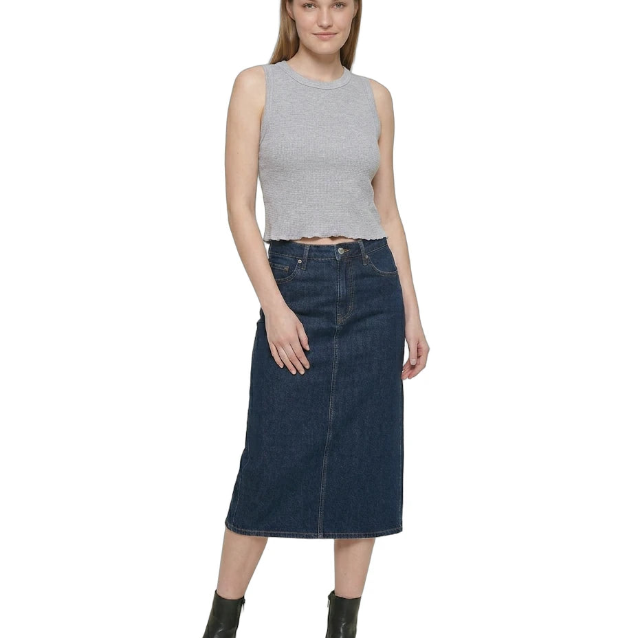 Woman wearing a gray sleeveless Calvin Klein top and dark blue denim skirt on a white background