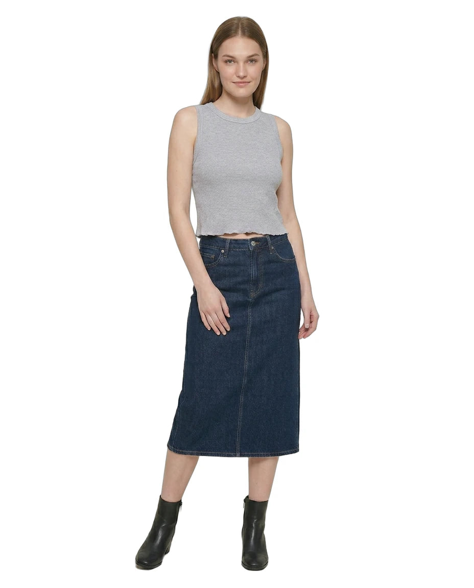 Woman wearing a gray sleeveless Calvin Klein top and dark blue denim skirt on a white background