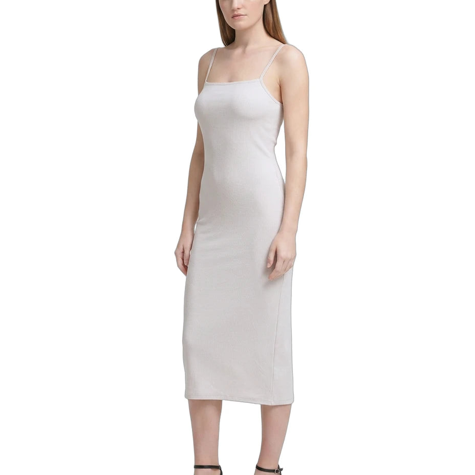 Woman wearing a white Calvin Klein dress on a white background