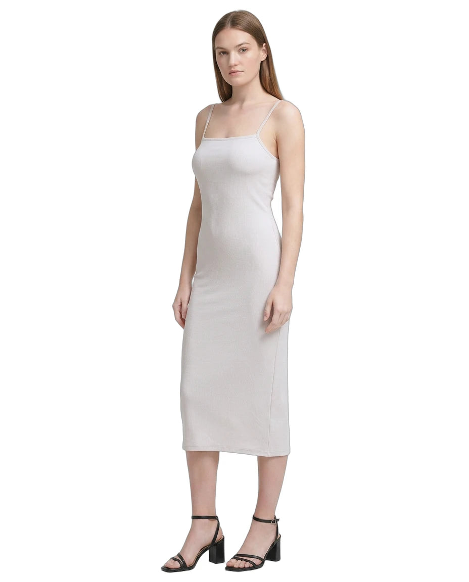 Woman wearing a white Calvin Klein dress on a white background