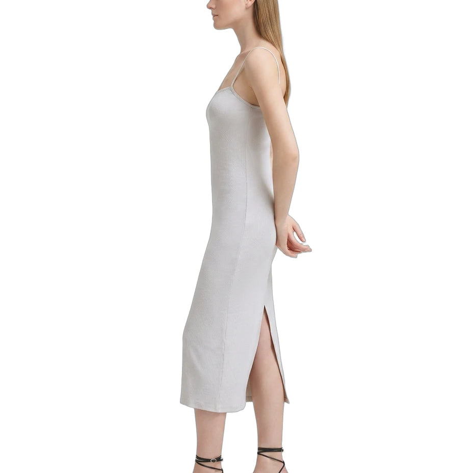Woman wearing a white Calvin Klein dress on a white background