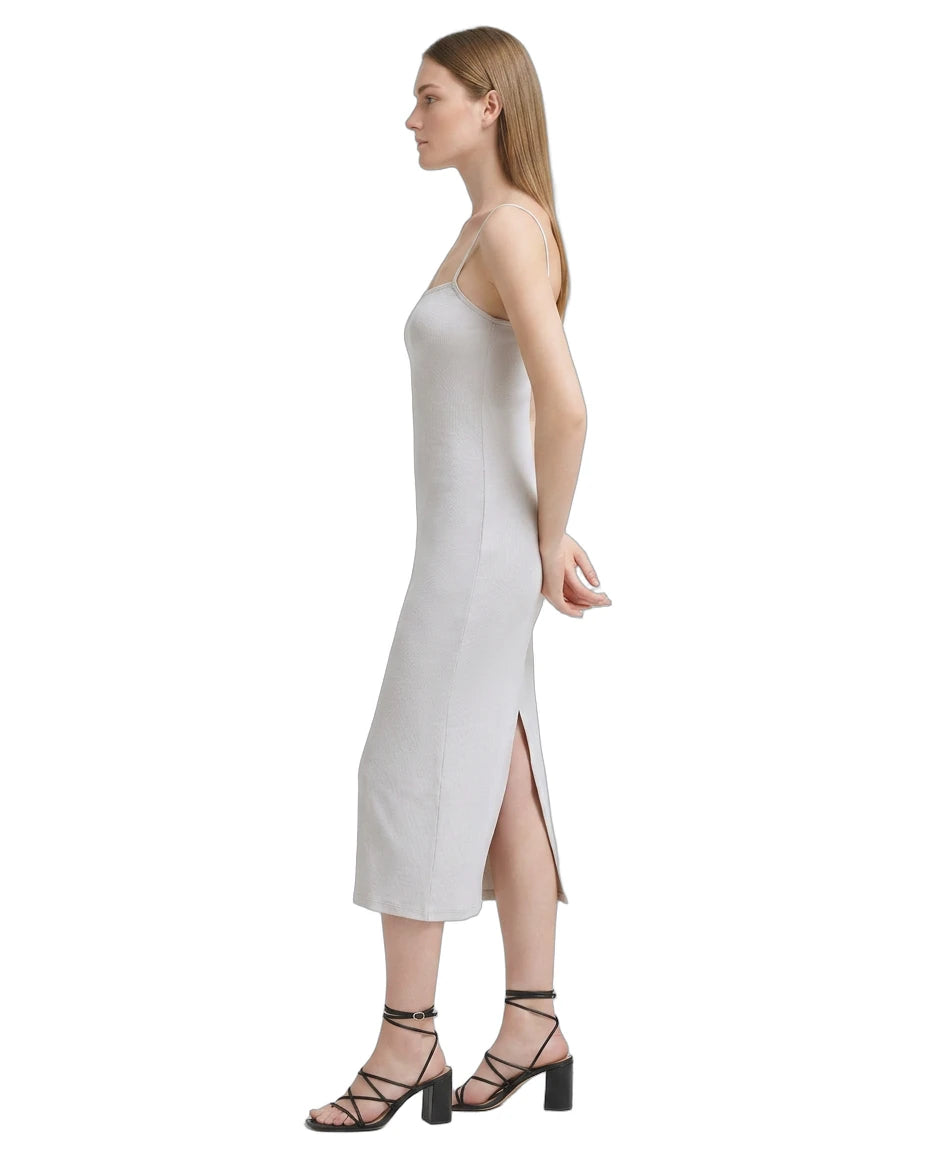 Woman wearing a white Calvin Klein dress on a white background