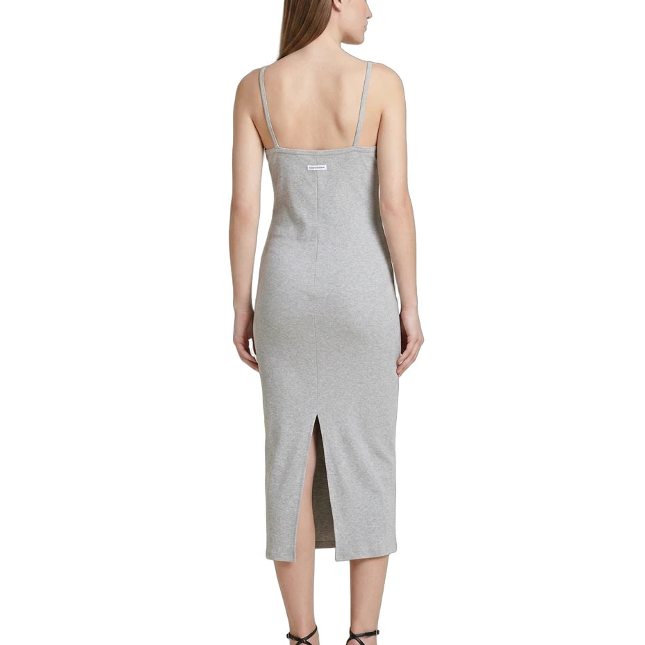 Woman wearing a gray Calvin Klein dress with a slit on a white background