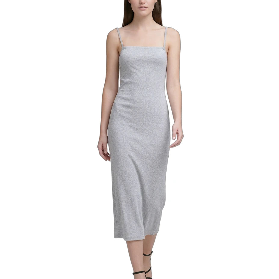 Woman wearing a light gray Calvin Klein dress on a white background