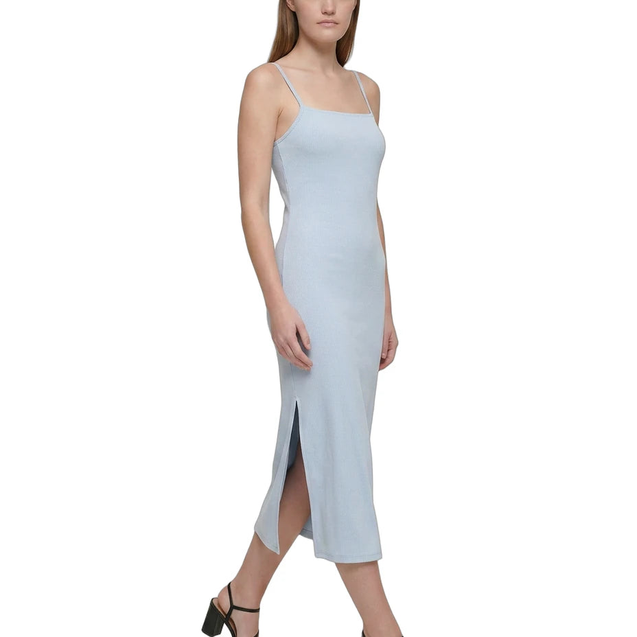 Woman wearing a light blue Calvin Klein dress on a white background