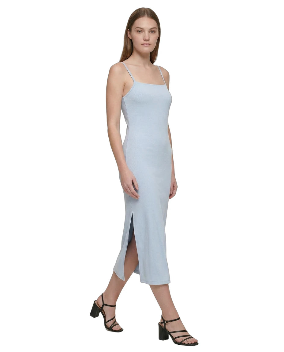 Woman wearing a light blue Calvin Klein dress on a white background