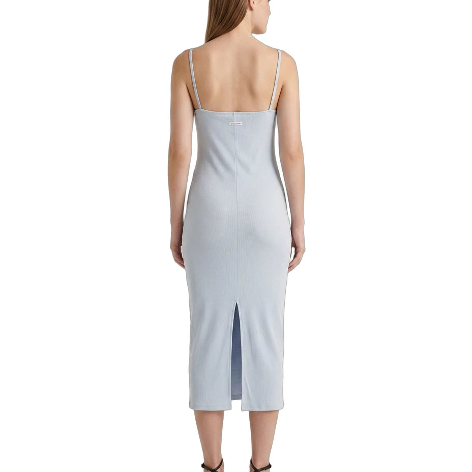 Woman wearing a light blue Calvin Klein dress on a white background