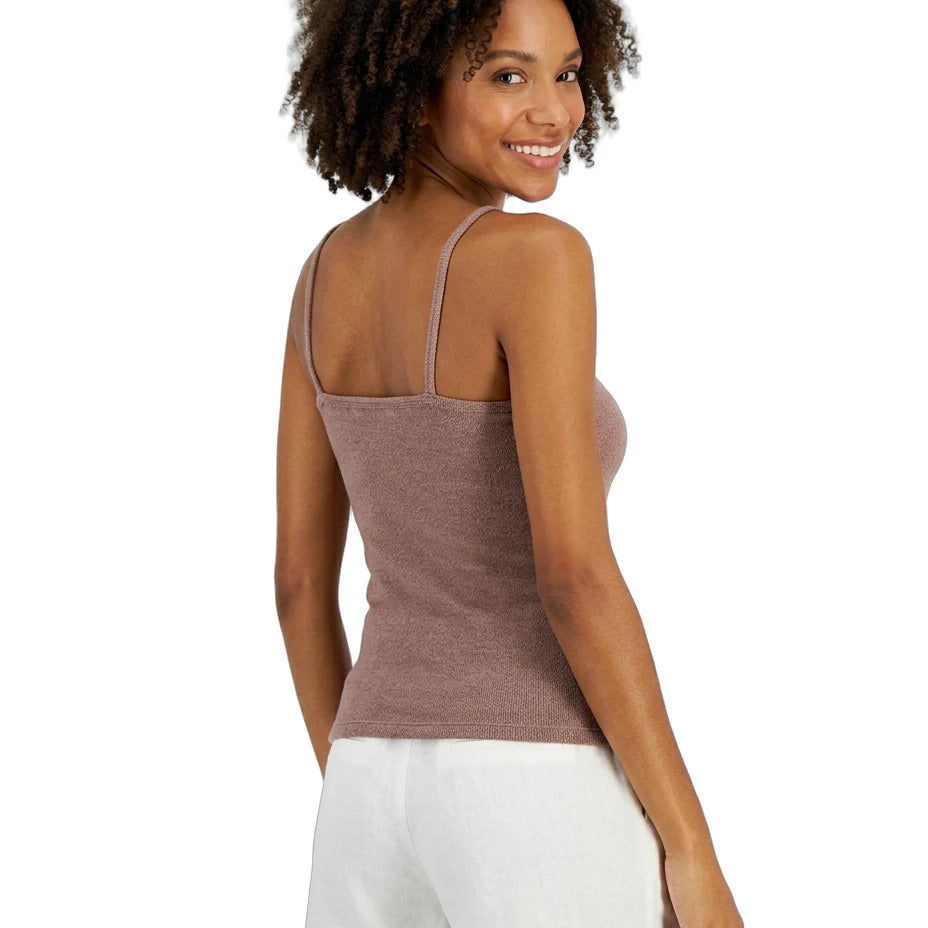 Woman wearing a brown Calvin Klein tank top and white shorts on a white background