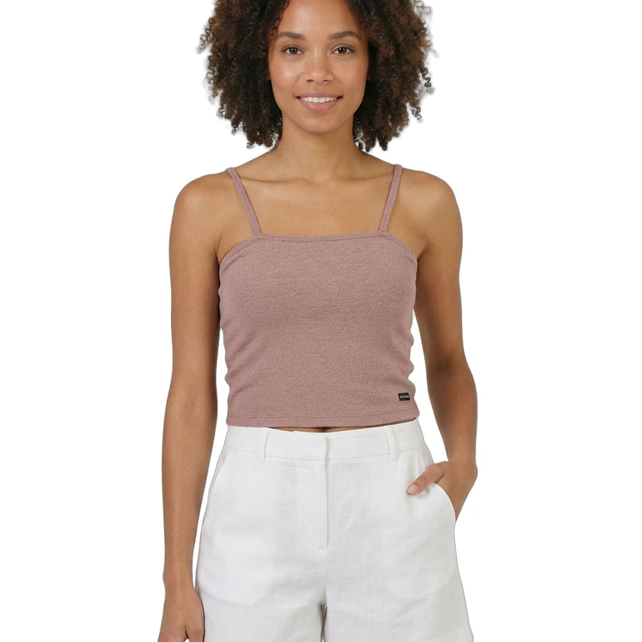 Woman wearing a brown Calvin Klein tank top and white shorts on a white background