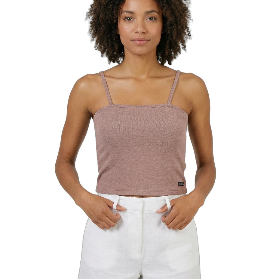 Woman wearing a brown Calvin Klein tank top and white shorts on a white background