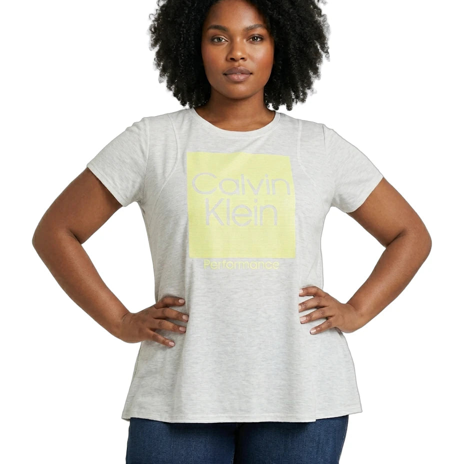 Woman wearing a Calvin Klein t-shirt with a yellow logo on a white background