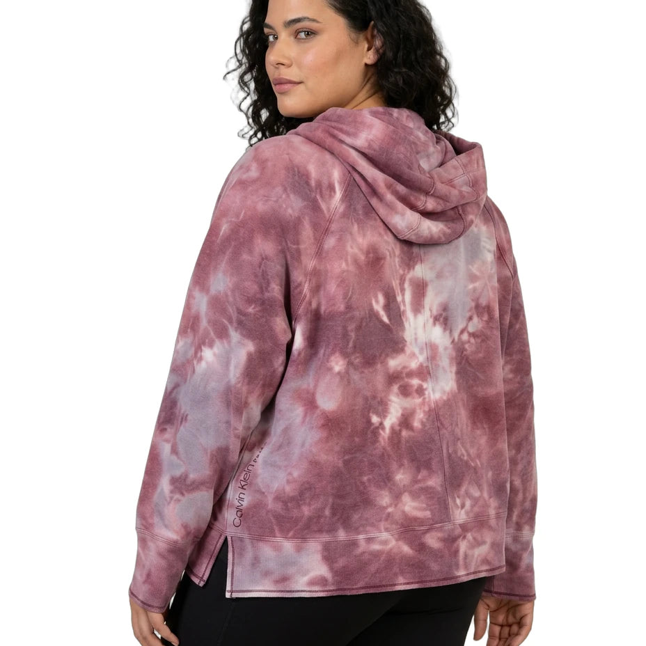 Person wearing a pink tie-dye hoodie on a white background