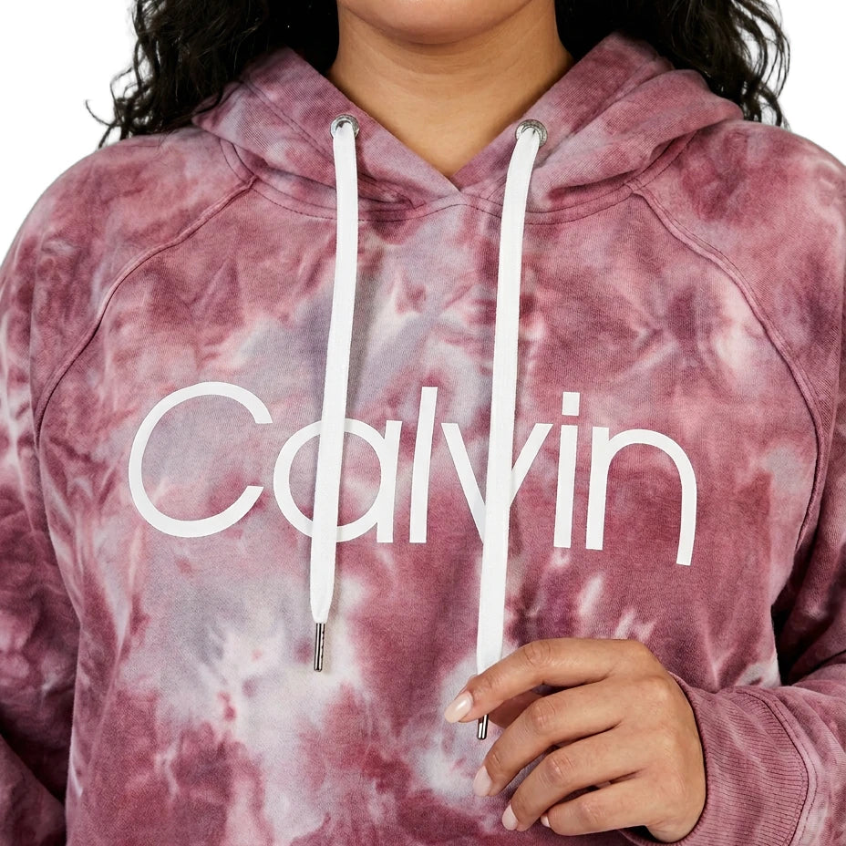 Person wearing a pink tie-dye hoodie with 'Calvin' branding