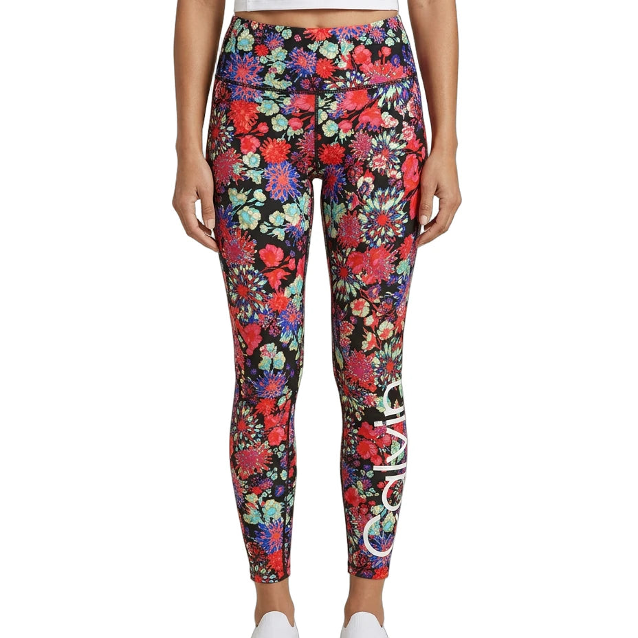 Person wearing colorful floral Calvin Klein leggings on a white background