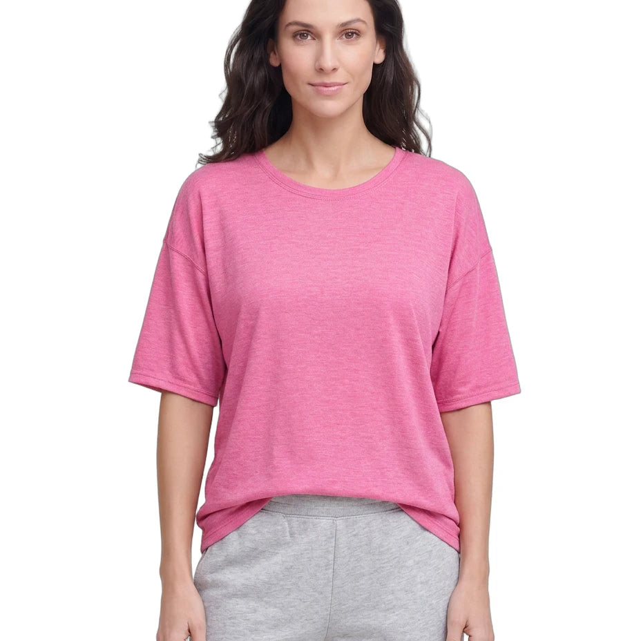 Woman wearing a pink shirt and gray pants on a white background