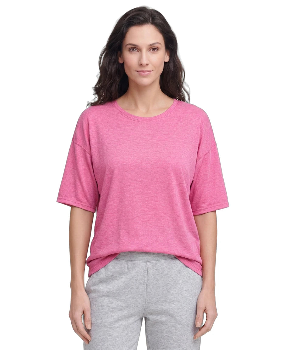 Woman wearing a pink shirt and gray pants on a white background