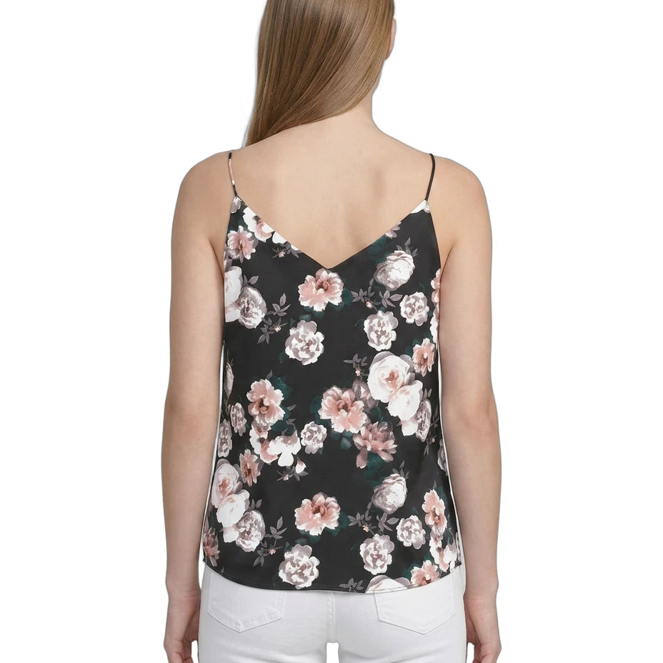 Woman wearing a floral camisole top on a white background