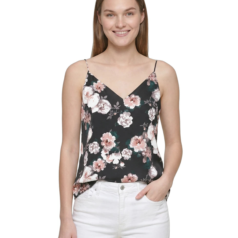 Woman wearing a floral camisole top on a white background