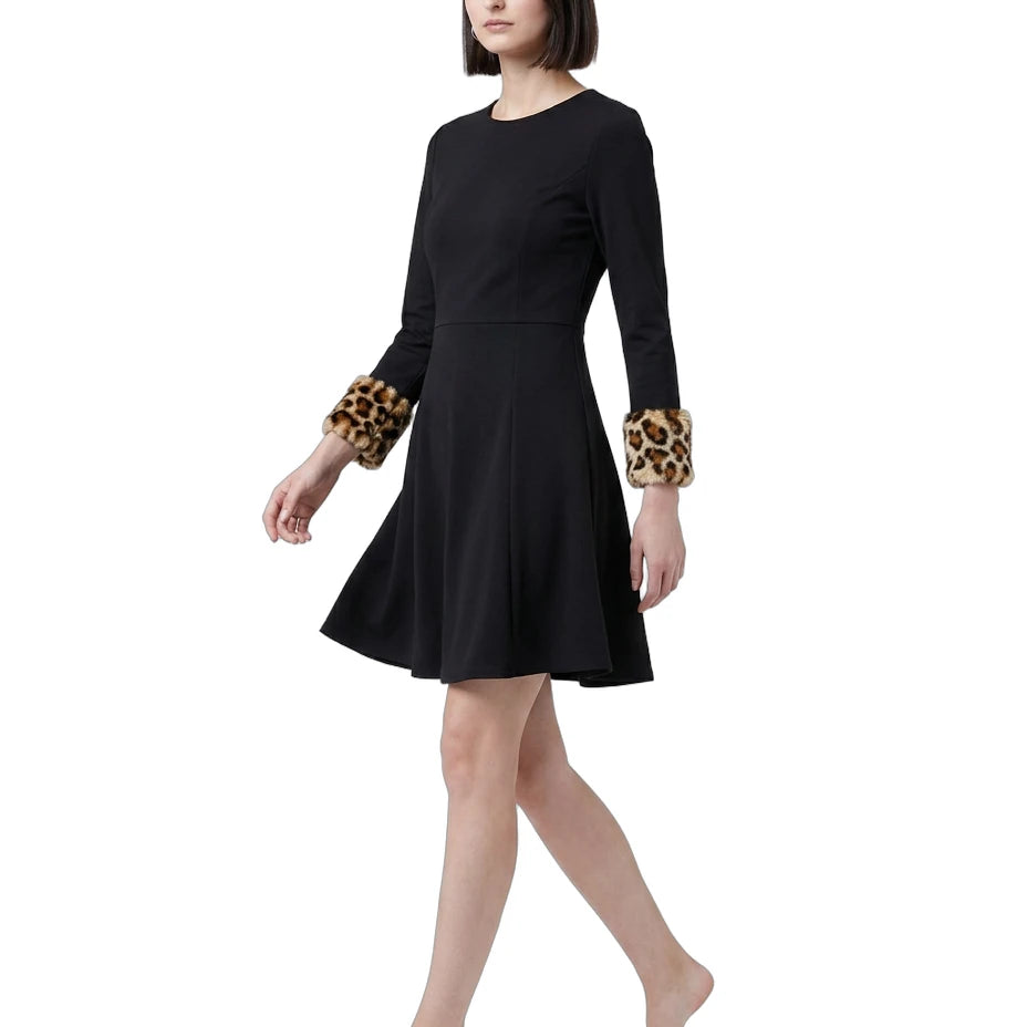 Black Calvin Klein dress with leopard print cuffs worn by a model on a white background