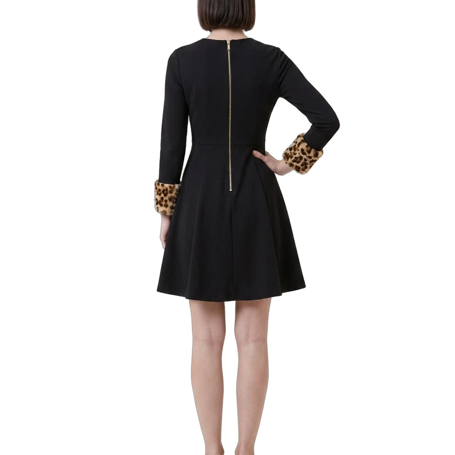 Black Calvin Klein dress with leopard print cuffs worn by a model on a white background