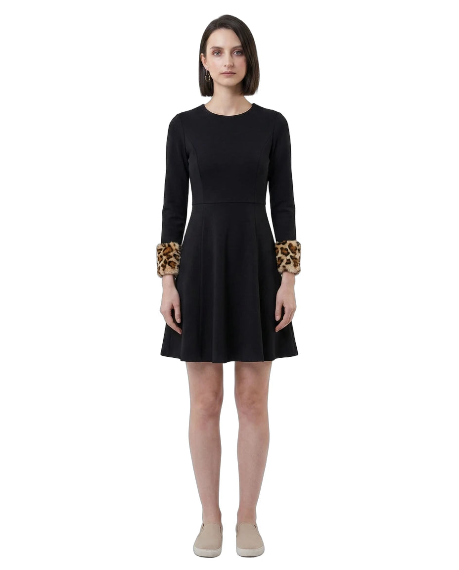 Black Calvin Klein dress with leopard print cuffs worn by a model on a white background