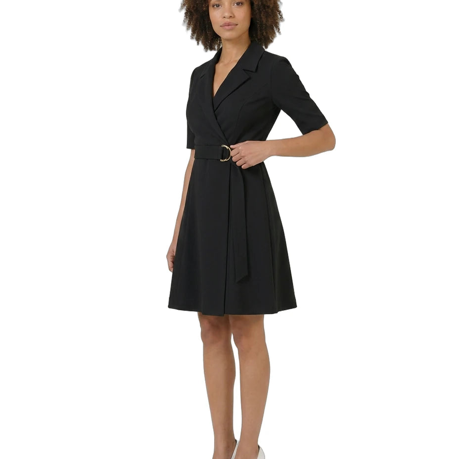 Woman wearing a black dress with a belt on a white background