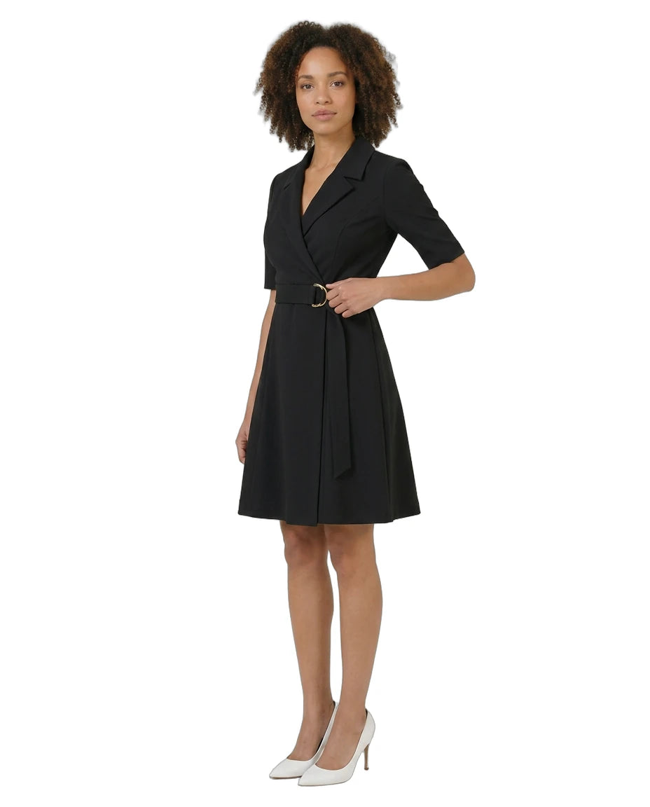 Woman wearing a black dress with a belt on a white background
