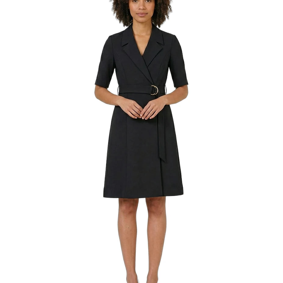 Woman wearing a black dress with a belt on a white background