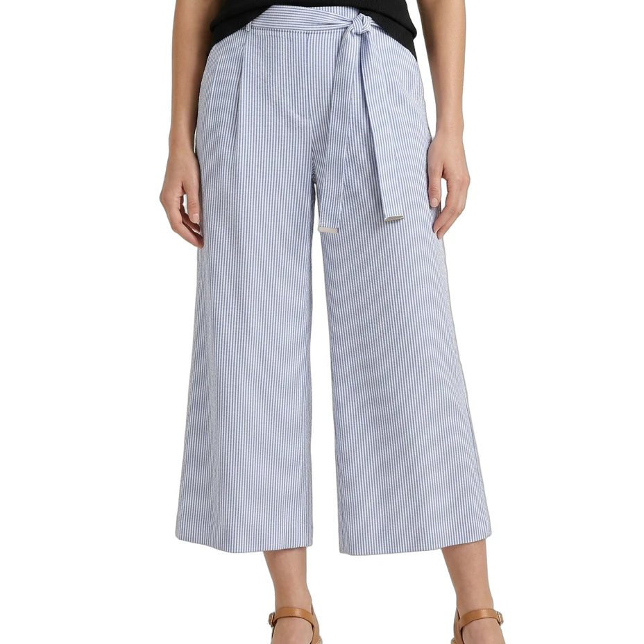 Woman wearing light blue striped wide-leg pants with a belt on a white background