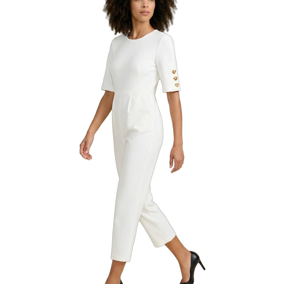 Woman wearing a white dress with gold buttons on a white background
