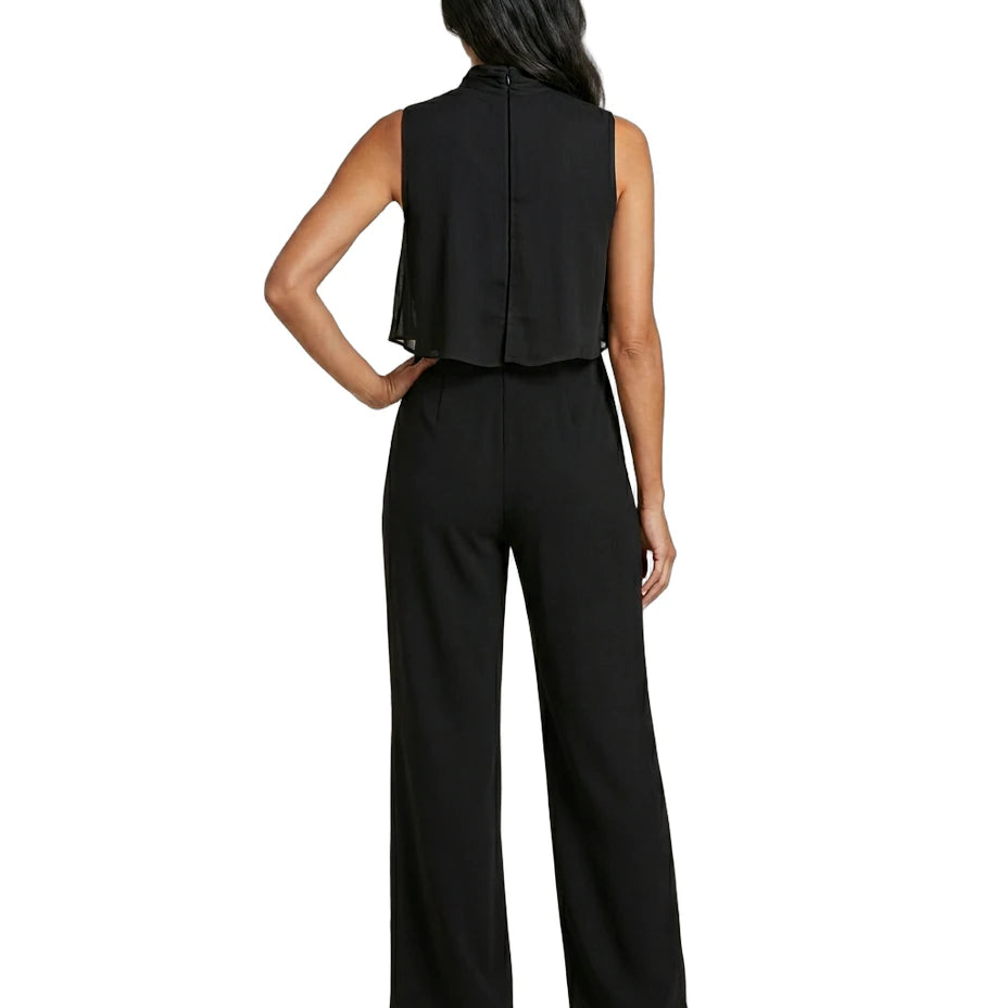 Woman wearing a black sleeveless top and wide-leg pants on a white background