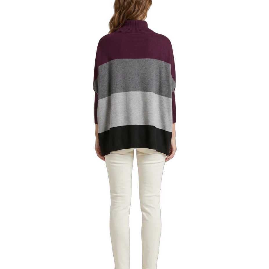 Woman wearing a striped Calvin Klein sweater with a white background