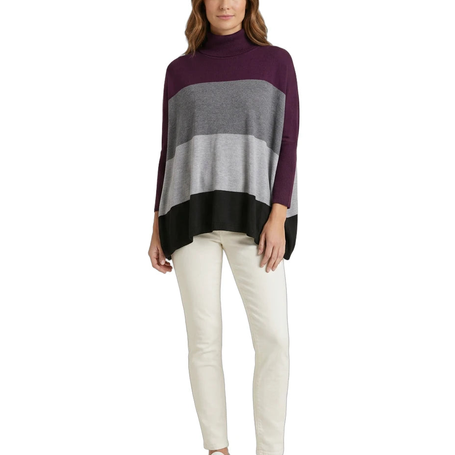 Woman wearing a striped Calvin Klein sweater and white pants on a white background