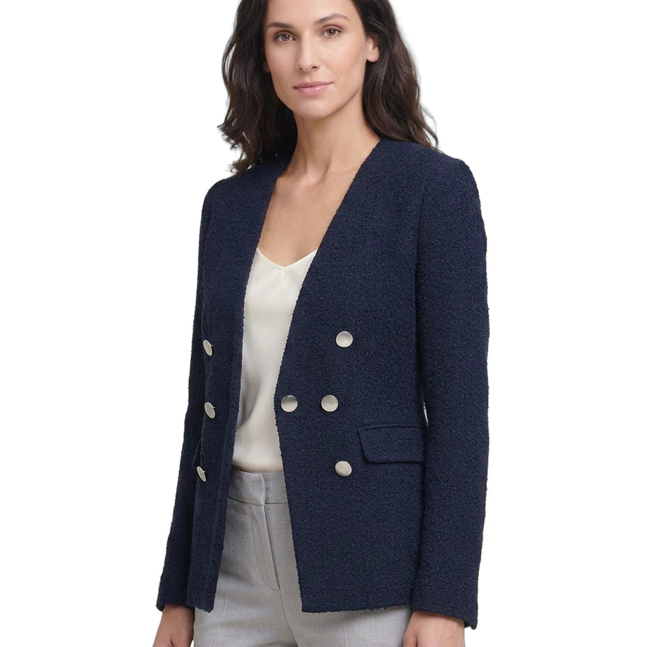 Woman wearing a navy blazer with white buttons on a white background