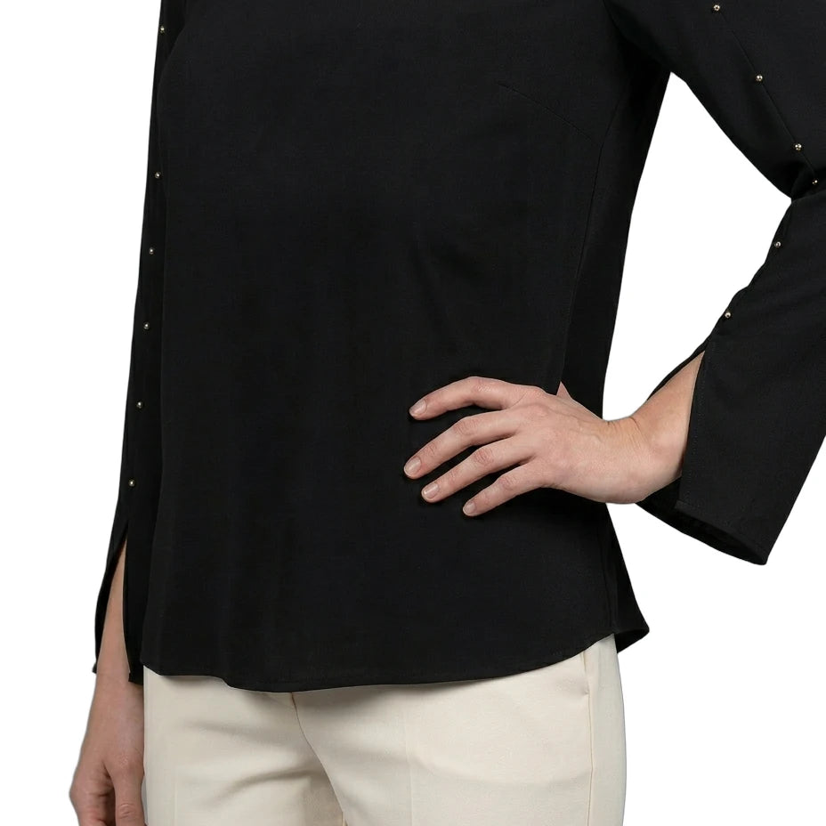 Black long-sleeve top with decorative trim worn by a person on a white background