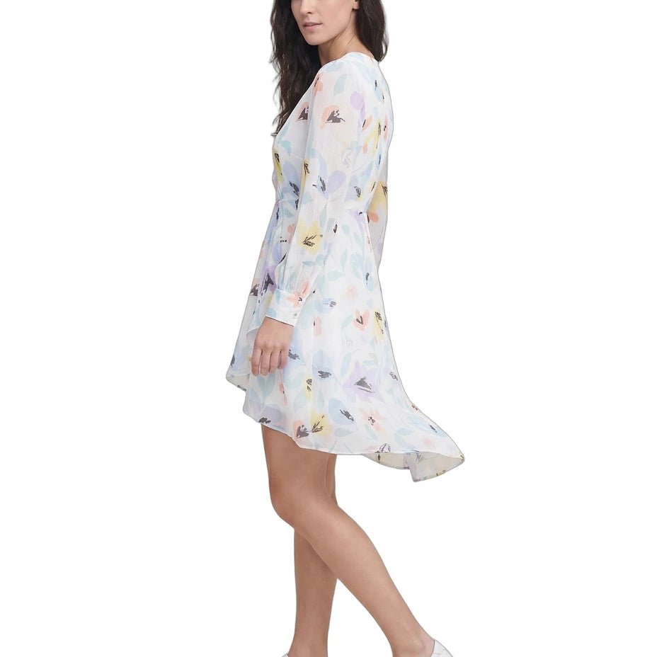 Woman wearing a floral Calvin Klein dress on a white background